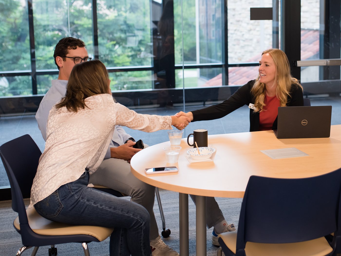 A handshake across a table during a meeting
